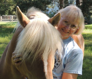 Colleen embracing a horse